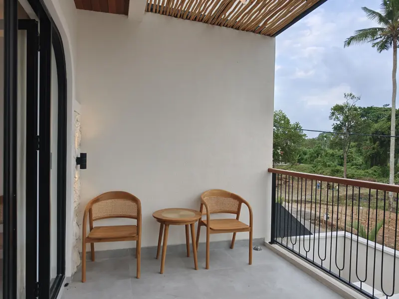Terrace with rattan chairs and palm trees