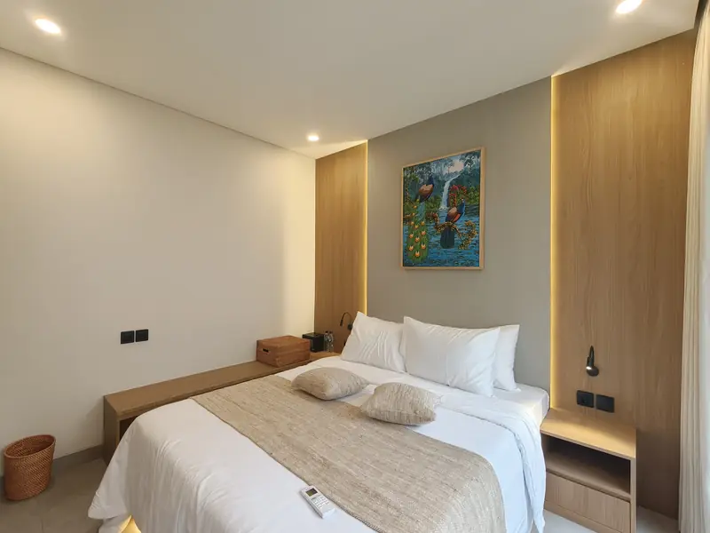 Bedroom with timber headboard and painting